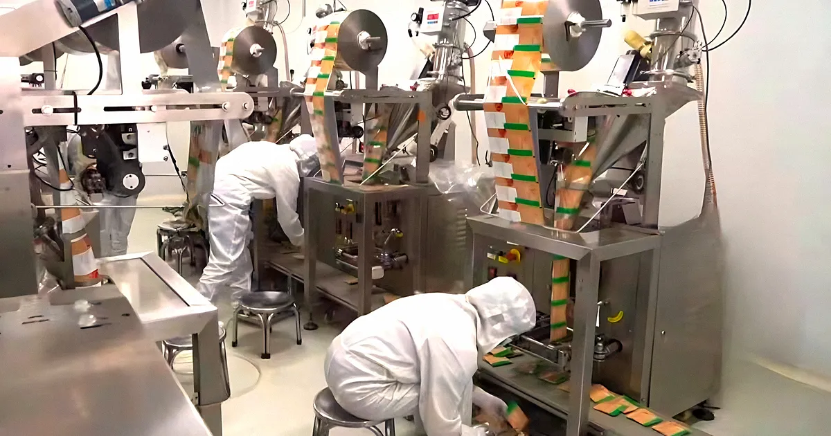 Stick-pack filling machines running in Herbal Treasure's clean production room, packing mushroom powder drink mixes